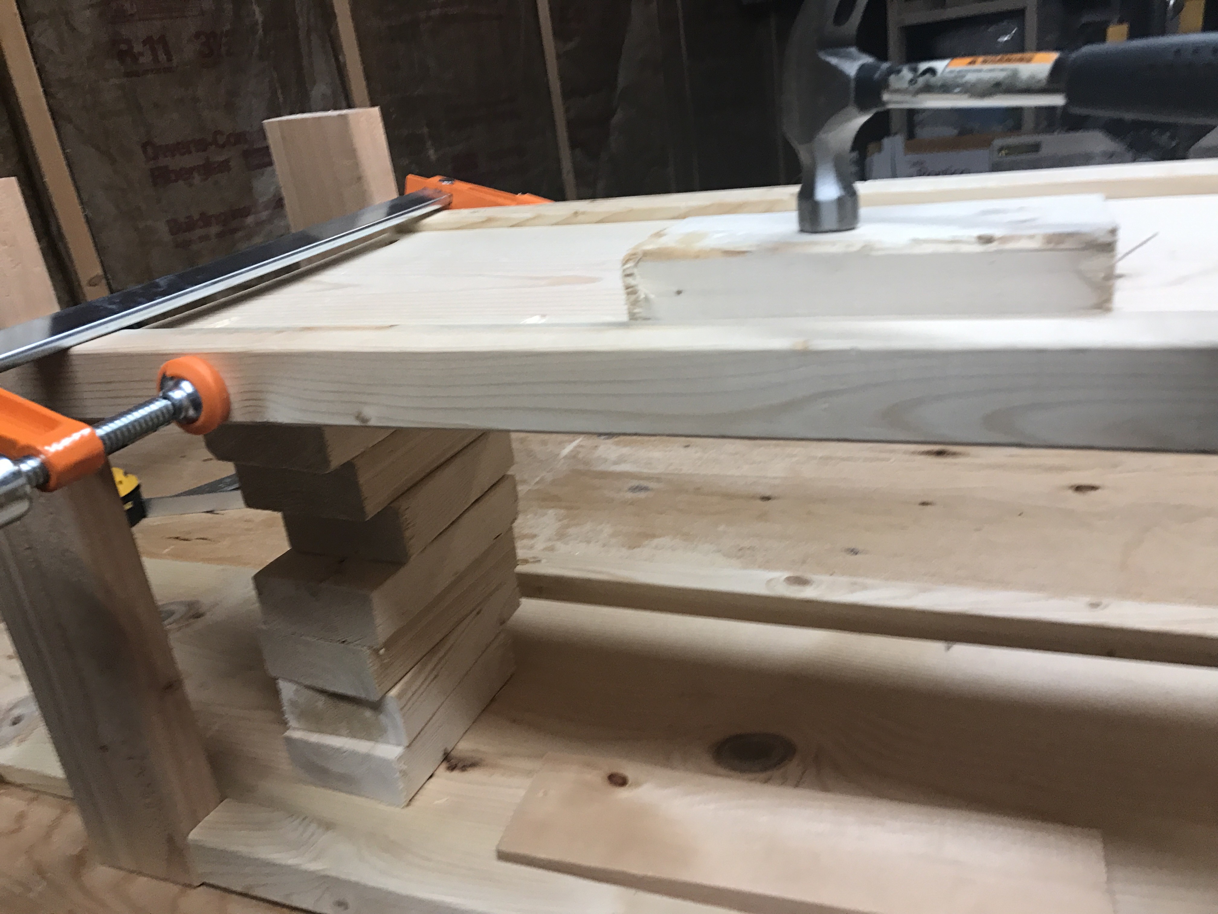 hammer on scrap wood to level out shelf