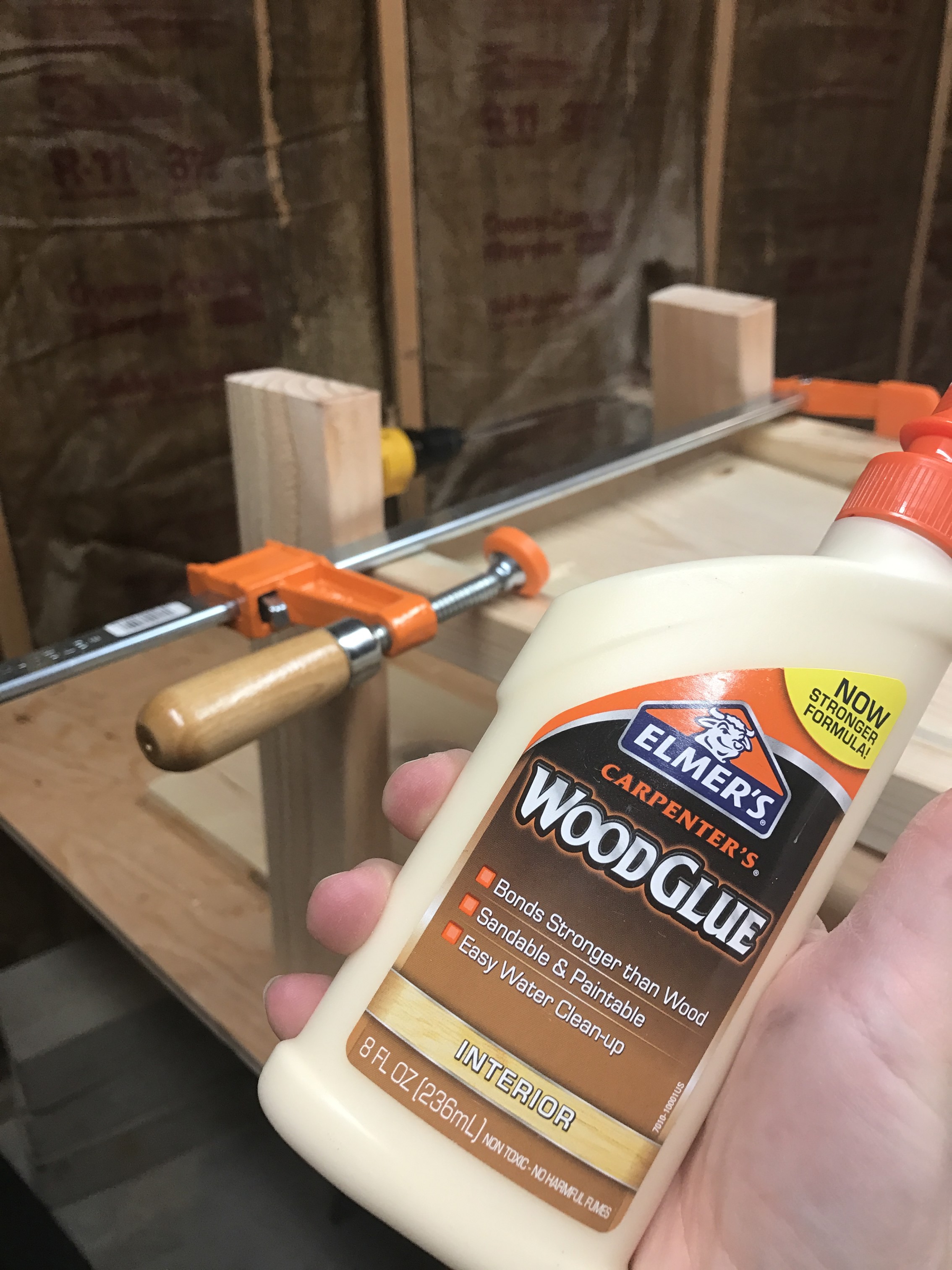 Elmer's wood glue with clamps in background