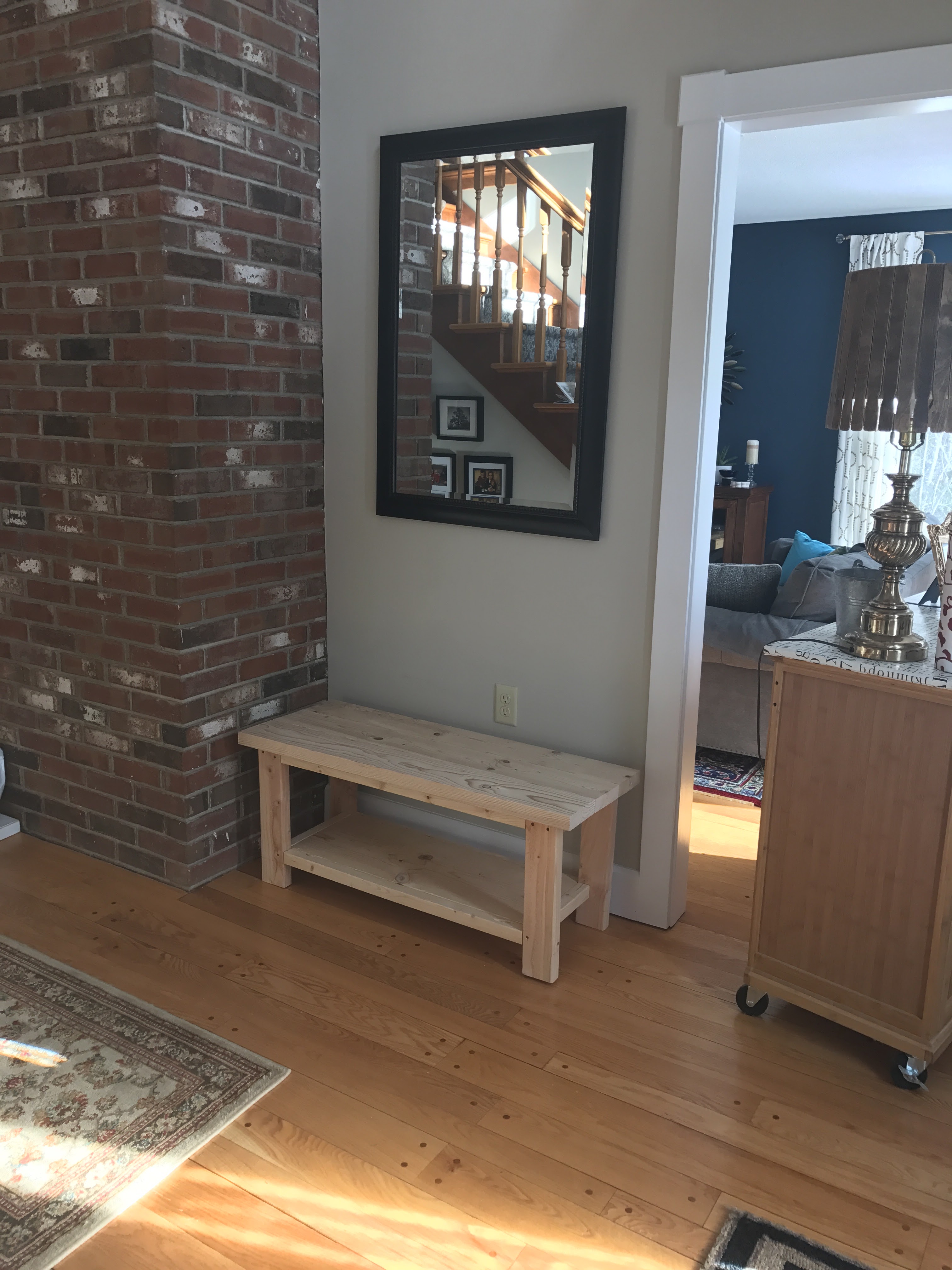 raw wood entryway bench in place